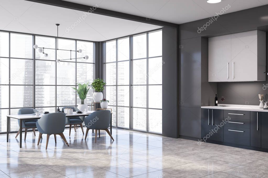 Corner of panoramic kitchen with gray walls, tiled floor, dark blue countertops and white cupboards. Dining table with blue chairs near the window. 3d rendering