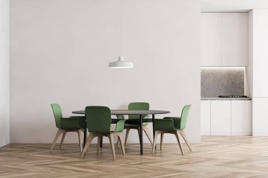 Beyaz ve gri duvarları olan ferah mutfağın içi, ahşap zemin, ocakta yapılmış beyaz tezgahlar ve yeşil sandalyeli gri yuvarlak yemek masası. 3d oluşturma