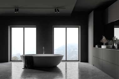 Gri duvarları, beton zemini, büyük aynalı lavabosu ve bulanık dağ manzaralı pencereler arasında duran rahat beyaz küveti olan şık bir çatı katı. 3d oluşturma