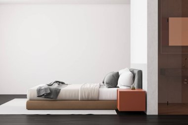 Lüks yatak odasının içinde beyaz duvarlar, koyu ahşap zemin, turuncu komodinli rahat kral yatağı ve yanında taş lavabo olan cam kapı. 3d oluşturma