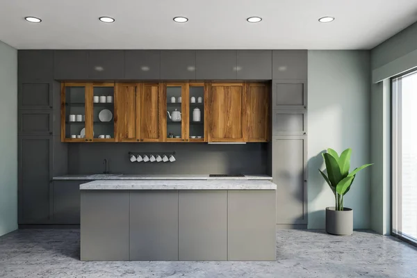 Interior of classic kitchen with light grey walls, concrete floor, gray countertops and wooden cupboards and comfortable grey island. 3d rendering