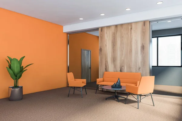 Comfortable waiting room in stylish office corner with gray, orange and wooden walls, carpeted floor and cozy orange sofa with armchairs standing near round coffee table. 3d rendering