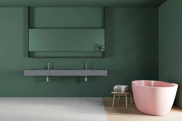 Interior of stylish bathroom with green walls, concrete and wooden floor, comfortable pink bathtub and stone double sink with horizontal mirror. Concept of spa. 3d rendering