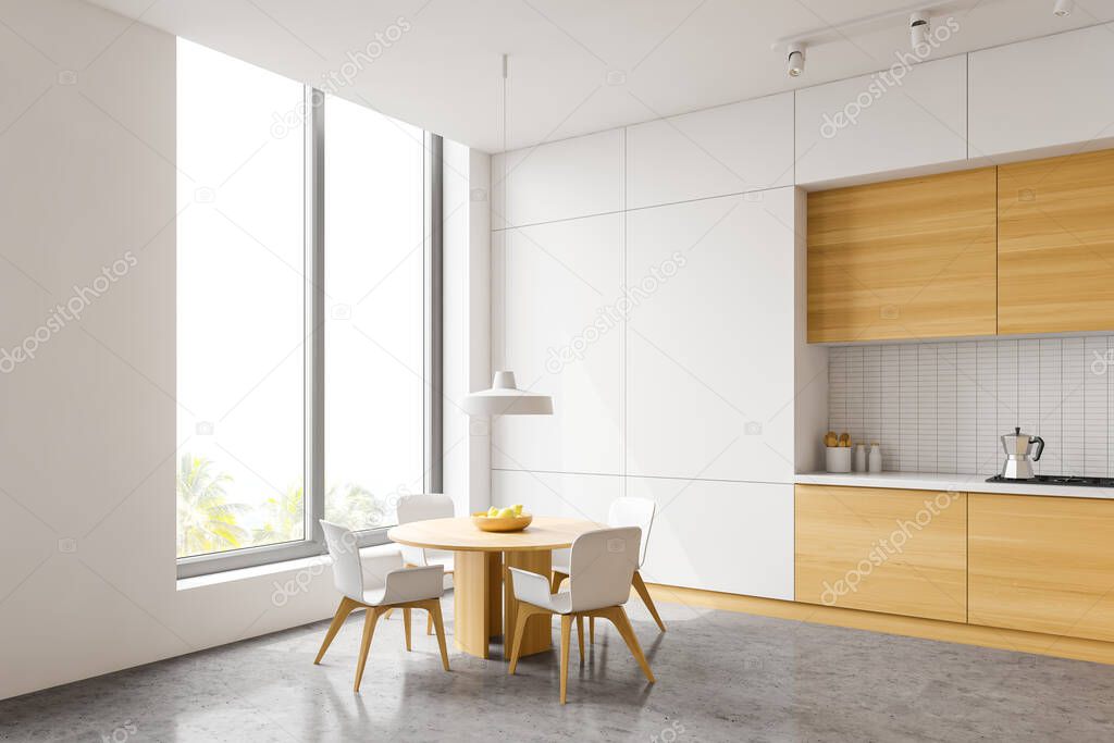 Corner of stylish kitchen with white tile walls, concrete floor, wooden countertops and cupboards, round dining table with white chairs and window with tropical view. 3d rendering