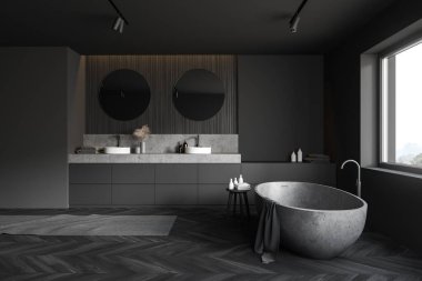 Gri ve koyu ahşap duvarları, ahşap zemini, yuvarlak aynaları ve rahat taş küveti olan gri tezgahların üzerinde duran çift lavabolu şık otel banyosu. 3d oluşturma