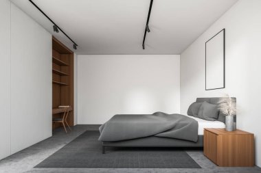 Beyaz duvarları, beton zemini, gri kral yatağı ve üzerinde sandalye ve raflar olan ahşap bir masa. Dikey model poster çerçevesi. 3d oluşturma