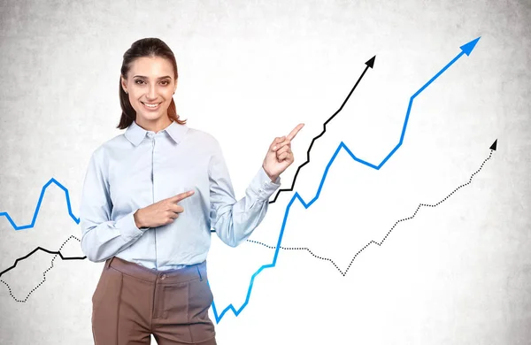 Cheerful Young Businesswoman Dark Hair Pointing Rising Graphs Drawn Concrete — Stock Photo, Image