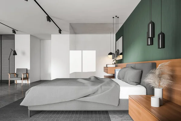 Side view of modern master bedroom with green and white walls, concrete floor, comfortable king size bed and glass wall bathroom with sink. Cozy armchair with floor lamp. 3d rendering