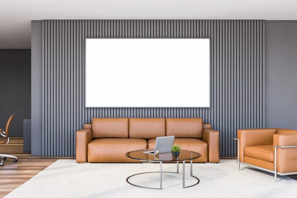 Interior of luxury office waiting room with grey walls, wooden floor, leather sofa and armchair standing near round coffee table with laptop. Horizontal mock up poster. 3d rendering