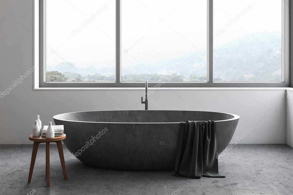 Close up of stone bathtub standing under window with blurry mountain scenery in modern bathroom interior with white walls and concrete floor. 3d rendering