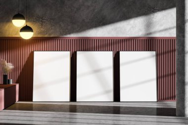 Boş odanın zemininde, koyu kırmızı beton duvarları ve şık tavan lambaları olan üç tane sahte poster var. Reklam ve sanat kavramı. 3d oluşturma