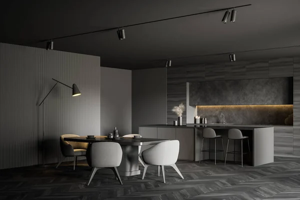 Corner of spacious cozy kitchen with grey walls, dark wooden floor, comfortable dining table with soft armchairs, bar with stools and wooden countertops in background. 3d rendering