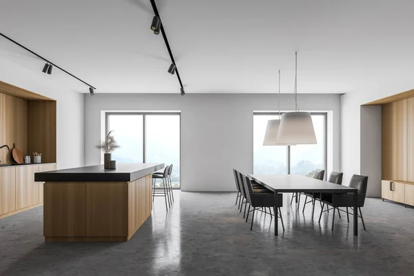Side view of spacious kitchen with white and wooden walls, concrete floor, wooden countertops, bar with stools and long dining table with massive lamps hanging above it. 3d rendering