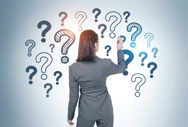Rear View Young Businesswoman Teacher Writing Question Marks Gray Wall — Stock Photo, Image