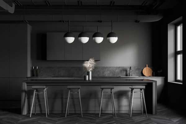Interior of modern industrial style kitchen with dark grey walls, wooden floor, grey countertops with built in sink and comfortable bar with stools. 3d rendering