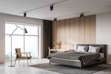 Geniş yatak odasının köşesinde beyaz ve ahşap duvarlar, beton zemin, rahat bir yatak ve masa ve sandalye ile ev ofisin köşesi. Pencerenin yanındaki koltukta bulanık dağ manzarası var. 3d oluşturma