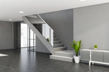 Gri duvarları, beton zemini, rahat beyaz ve gri dolabı ve merdivenleri olan şık bir oturma odası. 3d oluşturma