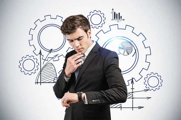 Thoughtful Young European Businessman Looking His Watch Standing Grey Wall — Stock Photo, Image