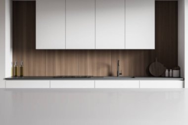 Ürününüz için gri masa bulanık minimalist mutfakta beyaz ve ahşap duvarlar, beyaz dolaplar ve lavabo ve ocakta yapılmış tezgahlar. 3D oluşturma maketi