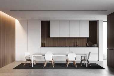 Beyaz ve ahşap duvarları, beton zemini, ocağı ve lavabosu olan beyaz tezgahı ve sandalyeli rahat yemek masası olan şık bir mutfak. 3d oluşturma