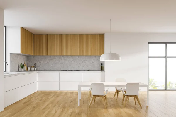 时尚厨房的内部 有白色和石墙 白色台面 木制橱柜和舒适的餐桌 有模糊的热带景色的窗户 3D渲染 — 图库照片