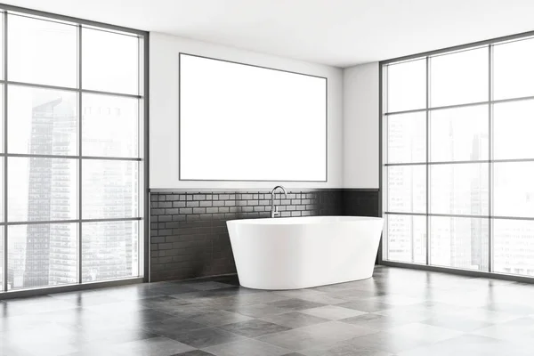 Corner of minimalistic bathroom with white and black brick walls, tiled floor, comfortable white bathtub and horizontal mock up poster frame. Window with blurry cityscape. 3d rendering