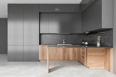 Gri duvarları, beton zemini, lavabo ve fırında yapılmış ahşap tezgahları, gri dolapları ve adası olan şık bir mutfak. 3d oluşturma