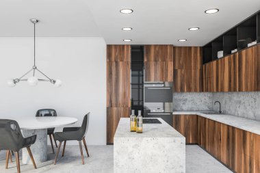 Modern mutfak, beyaz duvarlar, koyu ahşap tezgah ve dolaplar, tencere ve gri sandalyeli yuvarlak yemek masası olan bir ada. 3d oluşturma