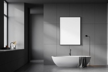 Gri duvarları, beton zemini, rahat beyaz küveti ve pencerenin yanında lavabosu olan şık bir banyo. Dikey model poster çerçevesi. 3d oluşturma