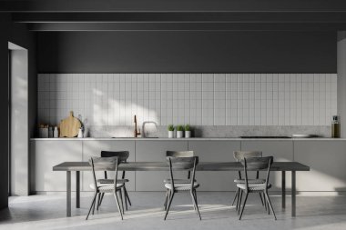 Beyaz ve koyu gri duvarları olan modern mutfak, yeşil tezgah ve dolaplar ve sandalyeli siyah ahşap yemek masası. 3d oluşturma