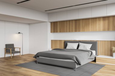 Beyaz ve ahşap duvarlı rahat yatak odasının köşesi, ahşap zemin, gri halıda duran kral yatağı ve yerde lamba olan koltuk. 3d oluşturma