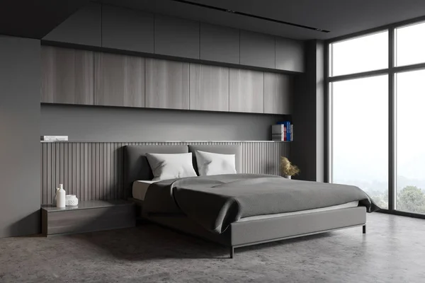 Corner of stylish master bedroom with grey and wooden walls, concrete floor, king size bed and two bedside tables. Blurry mountain view. 3d rendering