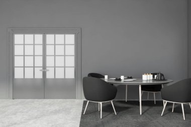Gri duvarları, beton zemini, siyah koltukları halıda ve kapalı kapısı olan minimalist yemek odasının içi. 3d oluşturma