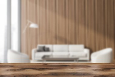 Ürününüz için ahşap masa, ahşap duvarlı, cam sehpanın yanındaki rahat kanepe ve zemin lambalı beyaz koltuklu bulanık ofis bekleme odasında. 3D oluşturma maketi