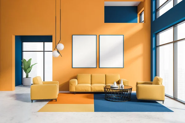 Interior of stylish living room with orange and blue walls, cozy orange sofa and armchairs near round coffee table and big windows with blurry cityscape. Mock up poster gallery. 3d rendering