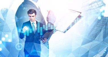 Confident man using digital graph interface in blurry abstract city with double exposure of CEO with documents. Global market and hi tech concept. Toned image. Elements of this image furnished by NASA clipart