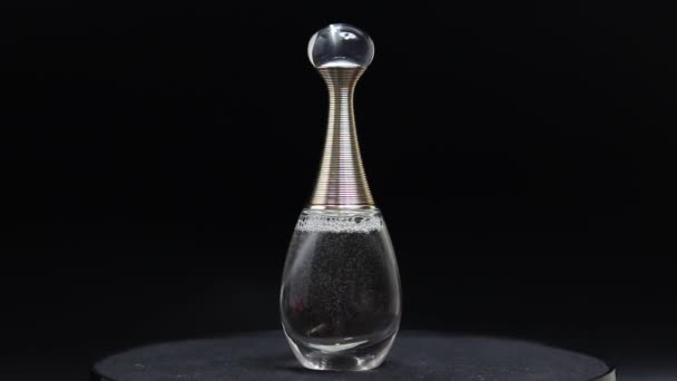 特写旋转香水瓶 黑色背景上的香水 — 图库视频影像