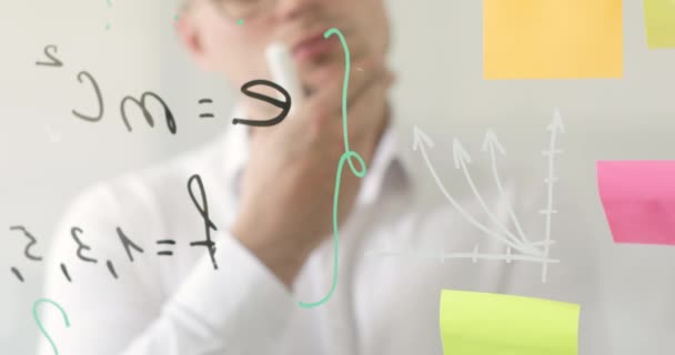 Scientist crosses out arrow on graph on transparent screen near formulas, notes. — Stock Video
