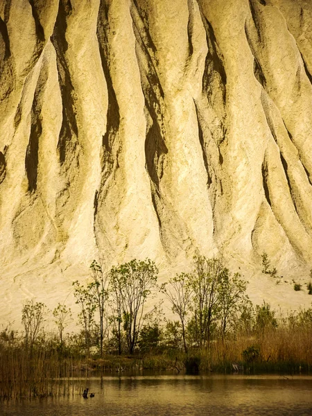 surreal landscape with white mountain in early spring