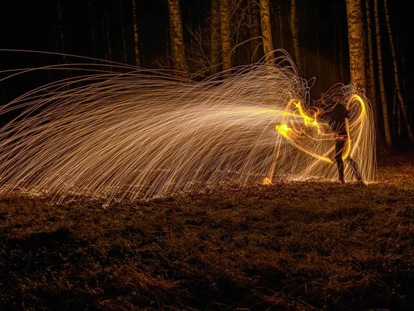 Fire circle spinning from steel wool creating spiral spark