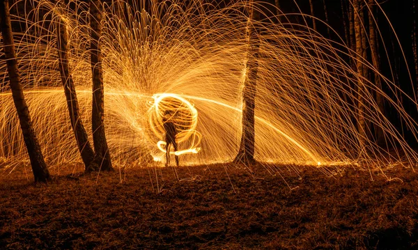 Fire circle spinning from steel wool creating spiral spark