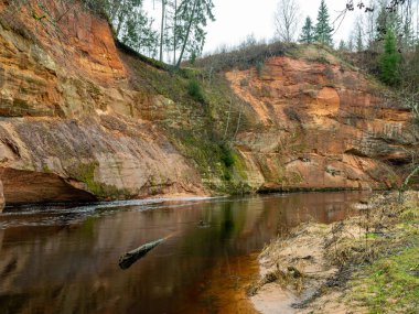 Nehir kıyısında kumtaşı kayalıkları olan manzara