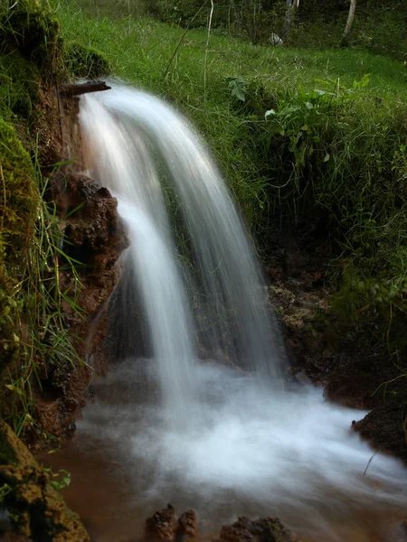 Soft waters running on rocks. Close-up of running water as a picture background