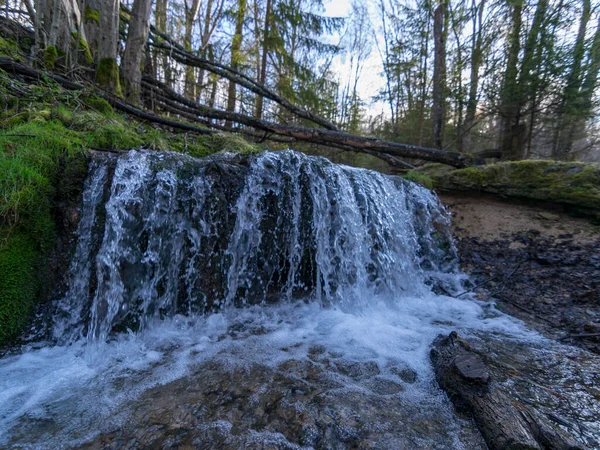 View of forest waterfall, deep forest waterfall landscape, mossy river banks, fallen trees