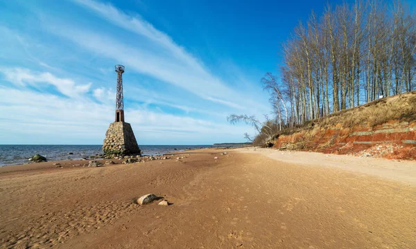 view of an old stone lighthouse by the sea, Kumrags lighthouse, Vidzeme rocky seaside in Latvia.