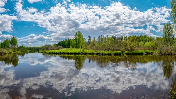 landscape with a beautiful river in spring, cloud reflections in the water, Seda River, Latvia