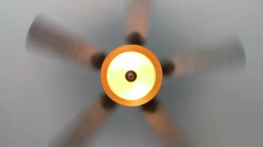 Elektrikli tavan vantilatörü ve sıcak ışık dönüyor. Nadir tavan vantilatörü düzlemi.