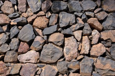 Arka plan için kırmızı turuncu granit duvarın dokusu