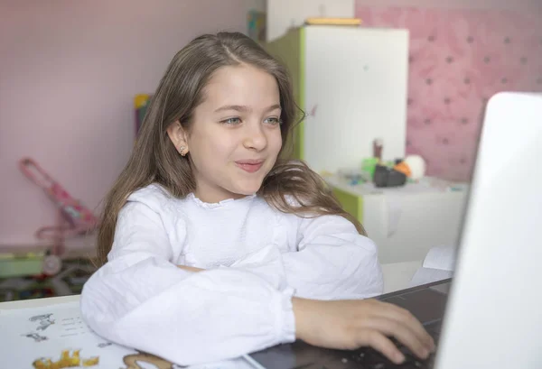 Distance learning online education. Stay at home. Covid-19 Coronavirus and Learning from home, Social distancing. Sickness school girl studying at home with digital tablet laptop notebook and doing homework.