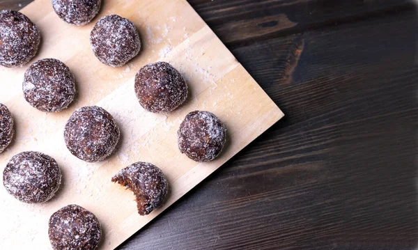 Homemade energy balls with dates, walnuts, almonds and coconut. Healthy sweet food. Copy space Energy balls in a bowl on a white background.Raw energy balls, all natural healthy raw energy bites